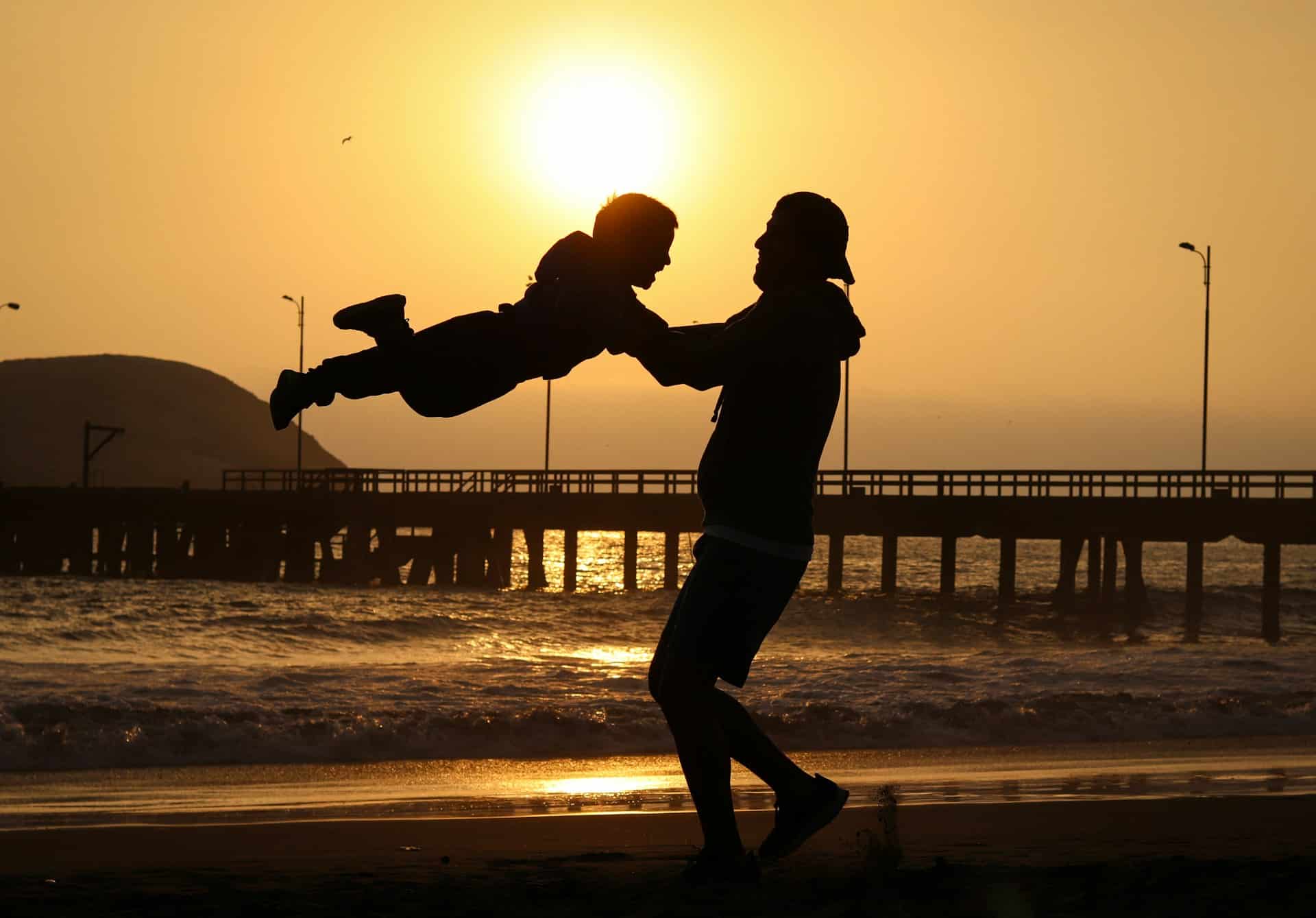 silhouetted father and son