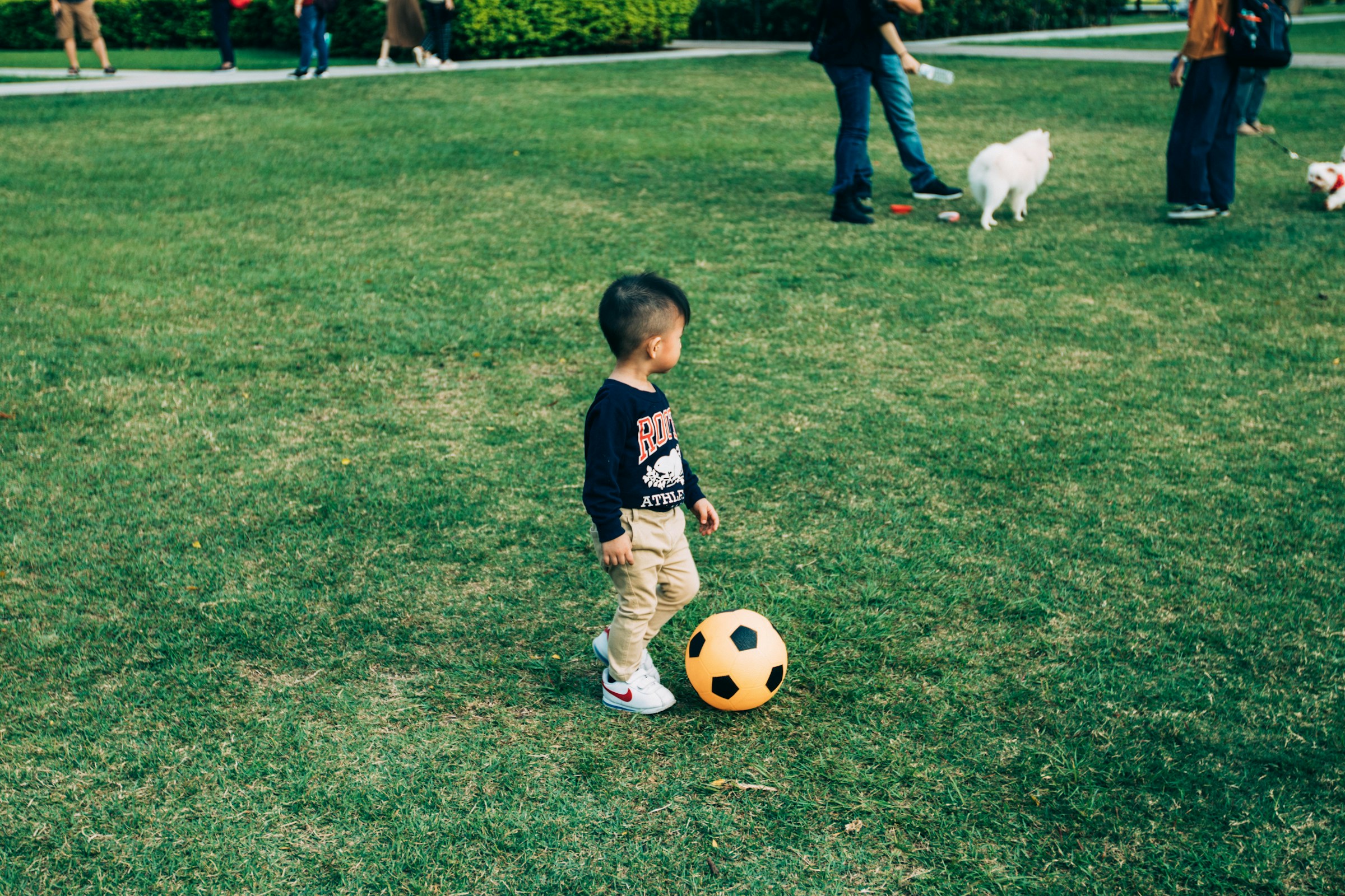 A young child playing with a soccer ball.