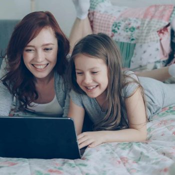 A mother and daughter using a laptop together
