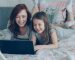 A mother and daughter using a laptop together